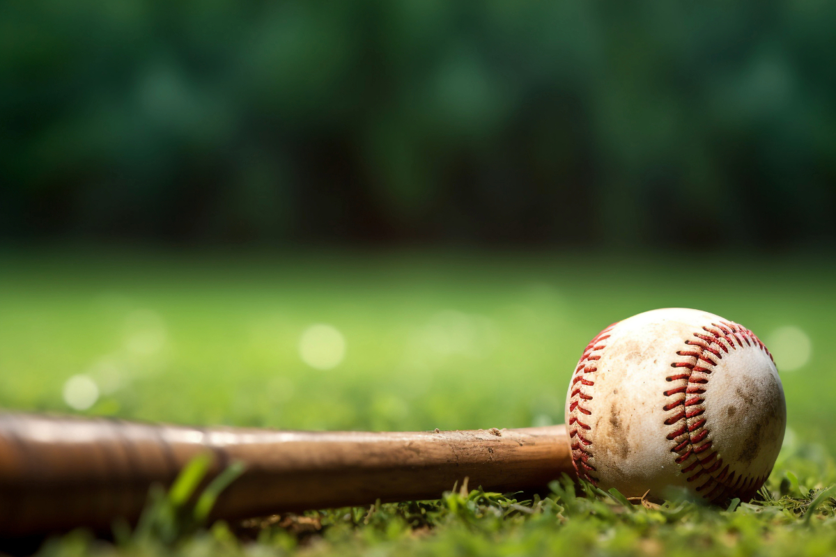 Baseball bat and ball on grass