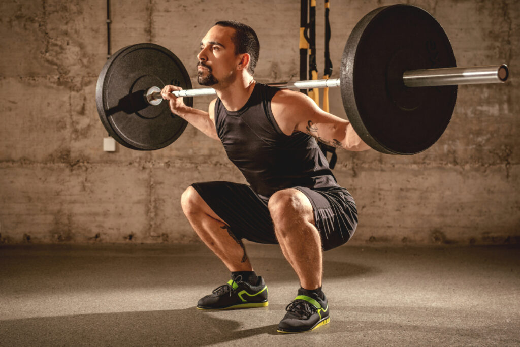 Male training barbell squats