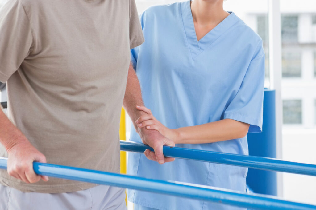 Physical Therapist helping patient walk